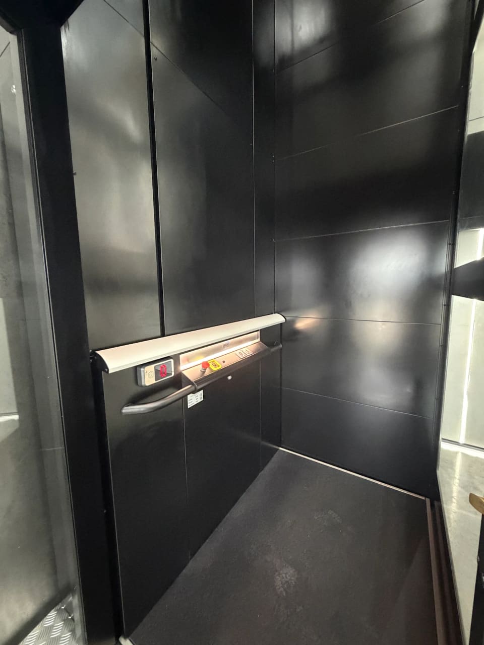 Completed glass lift with a dark metal frame