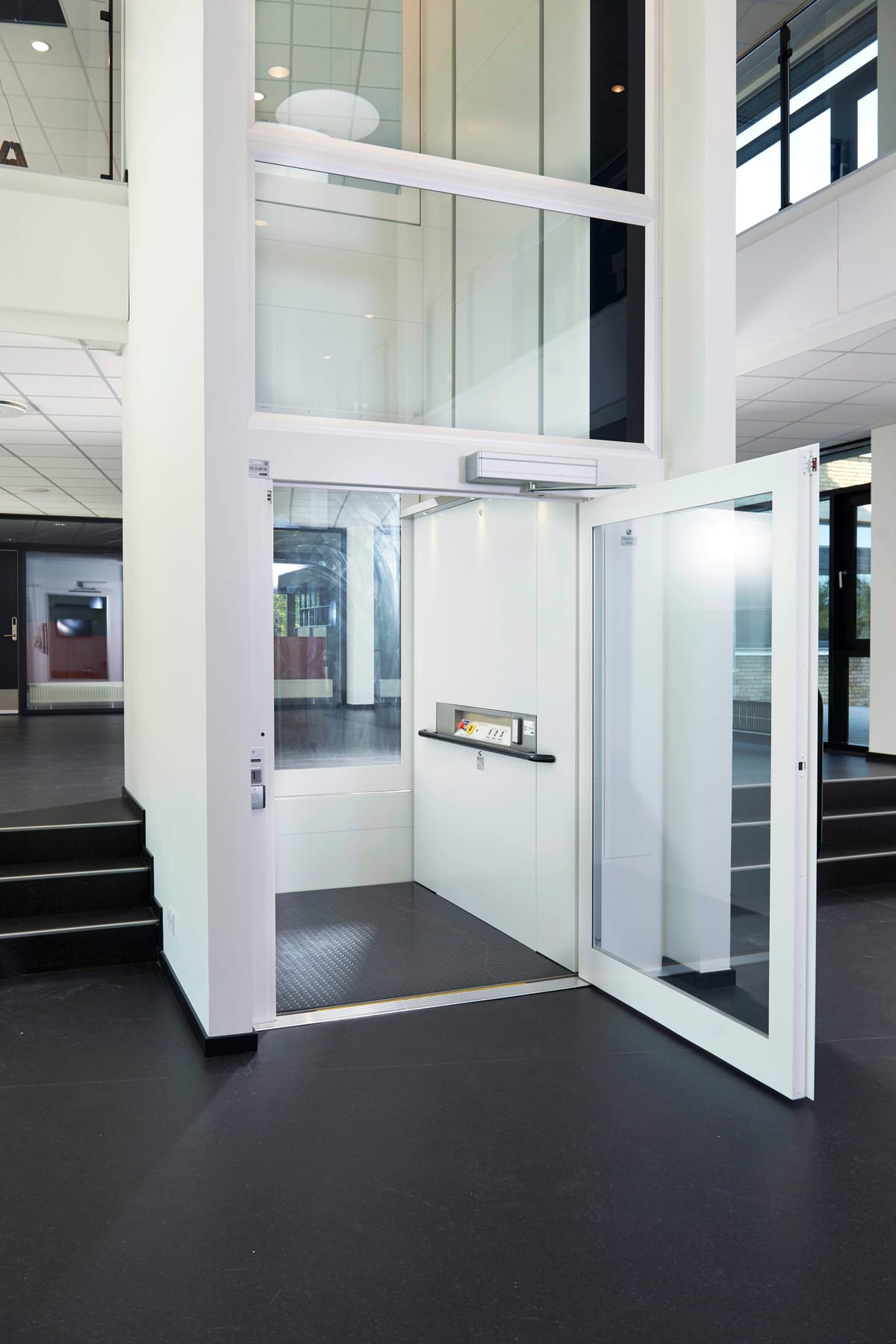 ILS 1K platform lift with the door open in a public building