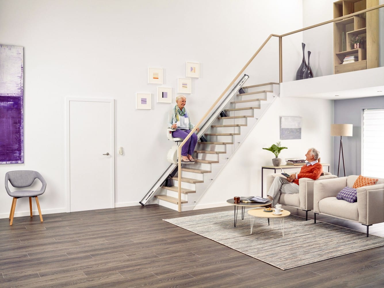 TKE S100 stairlift on a straight staircase in a bright home