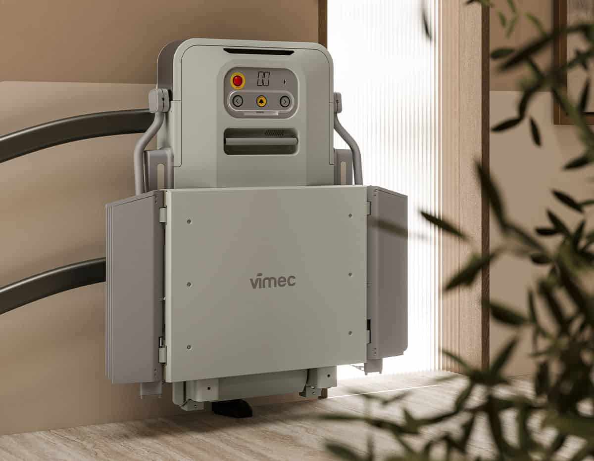 Vimec V6S platform stairlift folded neatly on a curved staircase rail